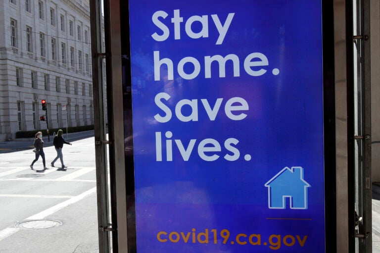 In San Francisco, a poster seen in March urges the public to socially distance in an effort to contain the spread of the coronavirus.