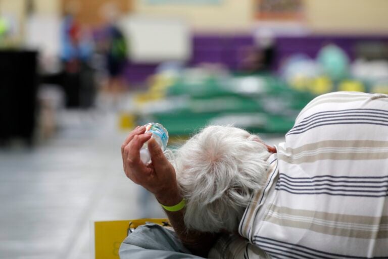 An evacuee lies on a cot at an evacuation shelter for people with disabilities in Stuart, Fla., in preparation for Hurricane Dorian on Sept. 1, 2019. Now, with the pandemic raging, officials across the South are trying to adjust their evacuation and shelter plans. (Gerald Herbert/AP Photo)