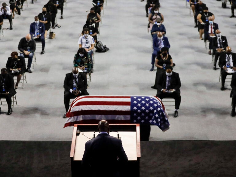 The Rev. Darryl Caldwell speaks as the casket of the late Rep. John Lewis, D-Ga., lies in repose during a service at Troy University in Troy, Ala., on Saturday.