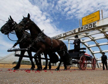 The casket of Rep. John Lewis moves over the Edmund Pettus Bridge