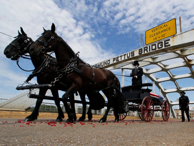 The casket of Rep. John Lewis moves over the Edmund Pettus Bridge