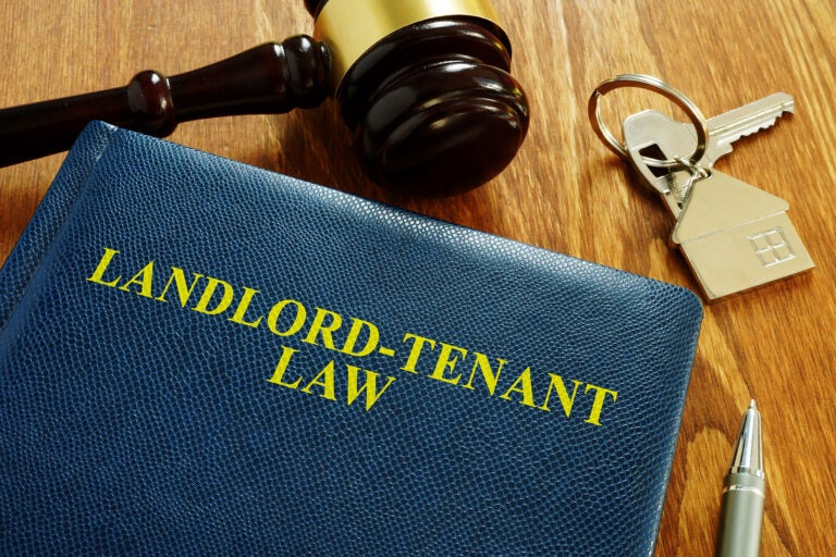 Landlord Tenant Law book and key from home. (Courtesy of BigStock)