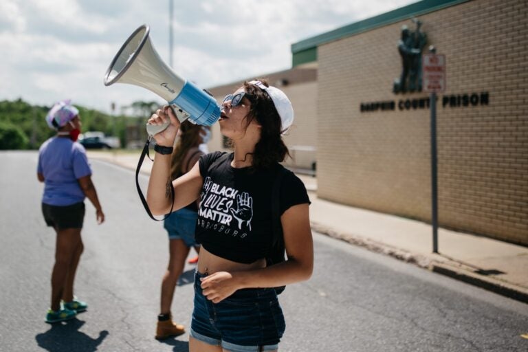 A protester with Black Lives Matter Harrisburg takes part in a protest outside Dauphin County Prison on June 30, 2020. Inmates inside the facility could be heard banging on the windows and holding up signs pleading for help. (Kate Landis/PA Post)