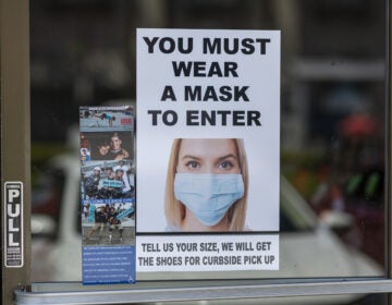 Masks are required for entry to a shoe store in Glendale, Calif. Most people follow social distancing and guidelines to wear masks when they enter retail stores and restaurants, but some customers don't comply.