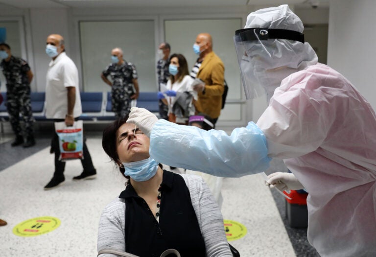 Passengers are tested for COVID-19 at Beirut International Airport on July 1. Passengers are tested for COVID-19 at Beirut International Airport on July 1. (Anwar Amro/AFP via Getty Images)
