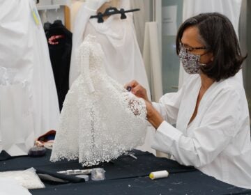 An employee sews a miniature dress in Dior's sewing workshop in Paris on July 4. This year Dior created a miniature collection for its haute couture show and presented it as a film. (Francois Guillot/AFP via Getty Images)