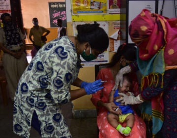 Medical staff in Mumbai, India, last week. A U.N. report warns that the coronavirus pandemic is interfering with children getting vaccinated. (Anshuman Poyrekar/Hindustan Times via Getty Images)