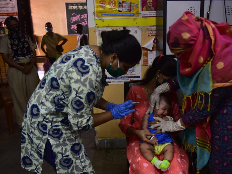 Medical staff in Mumbai, India, last week. A U.N. report warns that the coronavirus pandemic is interfering with children getting vaccinated. (Anshuman Poyrekar/Hindustan Times via Getty Images)