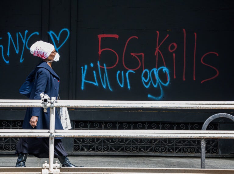 A pedestrian walks past anti-5G graffiti in the Flatiron District of New York in May. (Noam Galai/Getty Images)