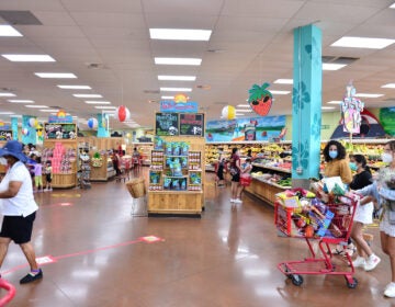 Trader Joe's says it is in the process of discontinuing some of its product branding. Here, shoppers buy groceries at a store last week in Pembroke Pines, Fla.