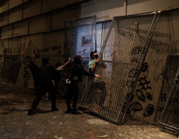 Protestors attempt to barricade the entrance to the U.S. District Court building on July 17, 2020 in Portland, Oregon.