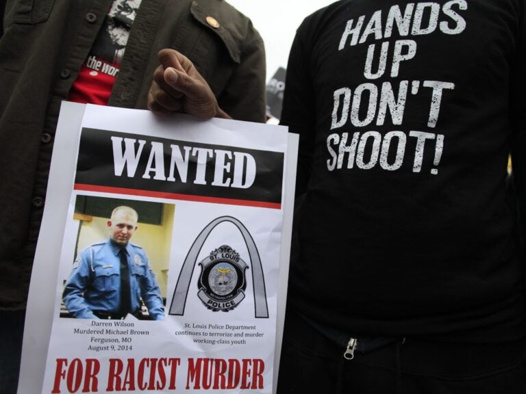 Demonstrators hold a sign in St. Louis, Mo., following the 2014 shooting death of 18-year-old Michael Brown. (Joshua Lott/AFP via Getty Images)