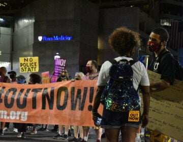 Jordan Johnson speaks to another protester at a demonstration in Philadelphia against federal law enforcement presence in Portland, Oregon. (Brett Sholtis/WITF)