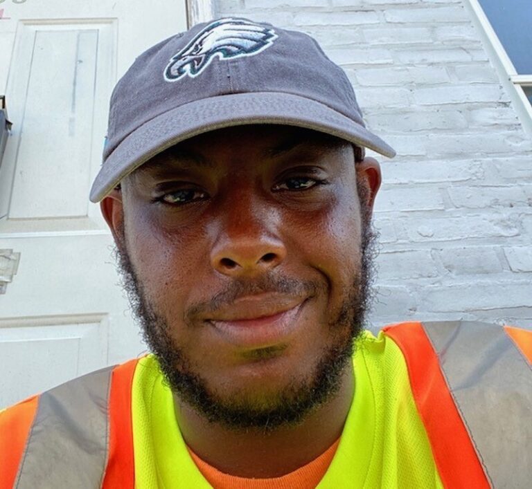 Terrill Haigler aka @_yafavtrashman smiles during a shift as a city sanitation worker. (Courtesy of Terrill Haigler)