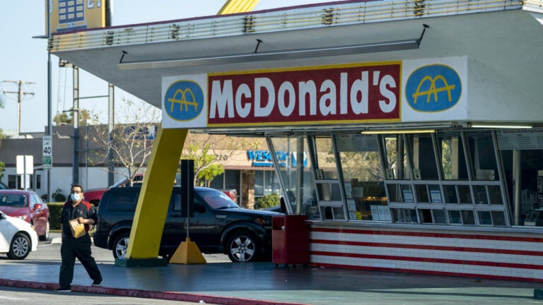 McDonald's will require all customers at its U.S. restaurants to wear a face mask, starting Aug. 1, the company says. Here, a customer wears a mask at the oldest operating McDonald's Corp. restaurant, in Downey, Calif., in April.