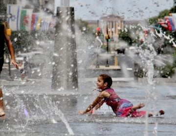 Kids cool off in the LOVE Park fountain