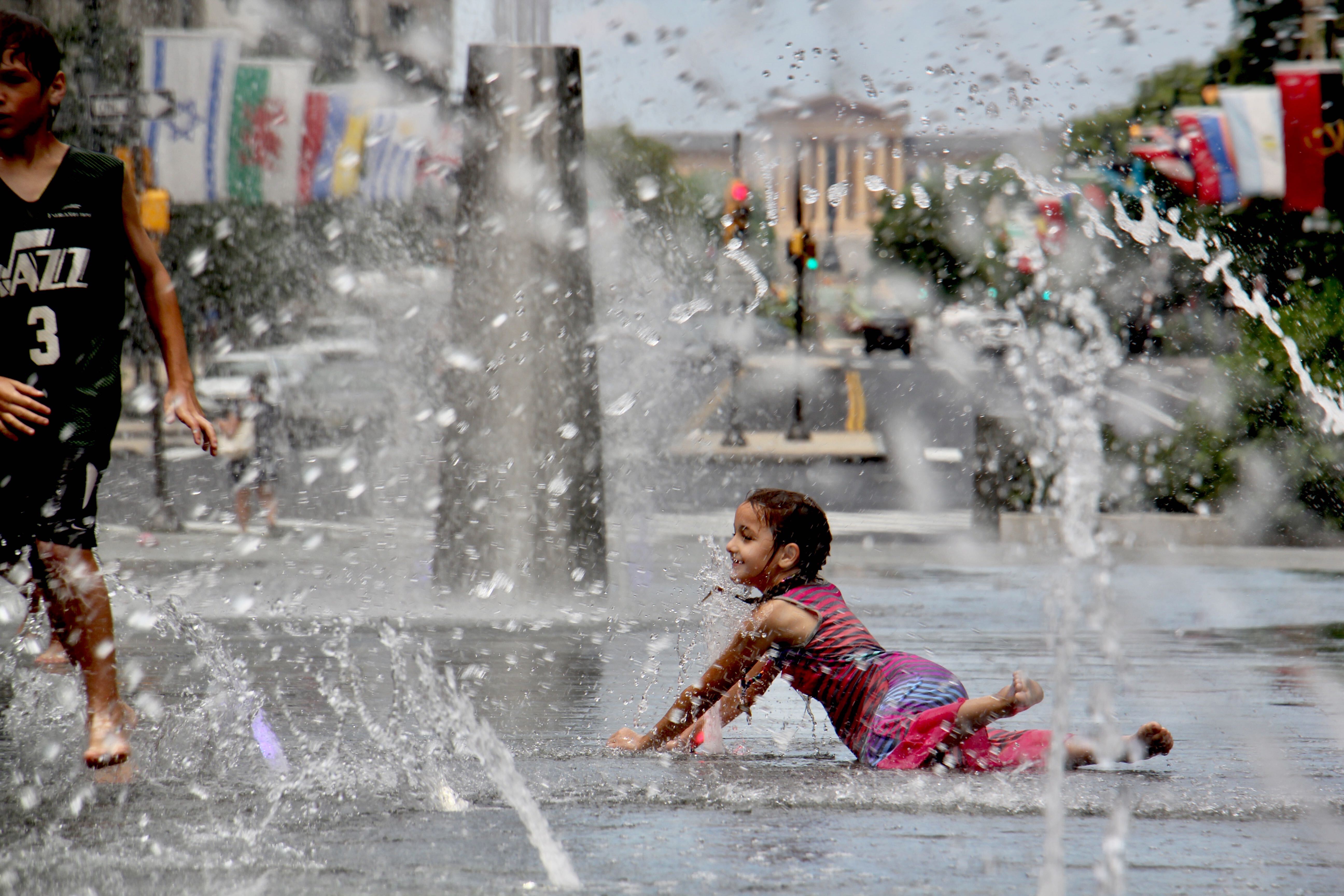 Kids cool off in the LOVE Park fountain.