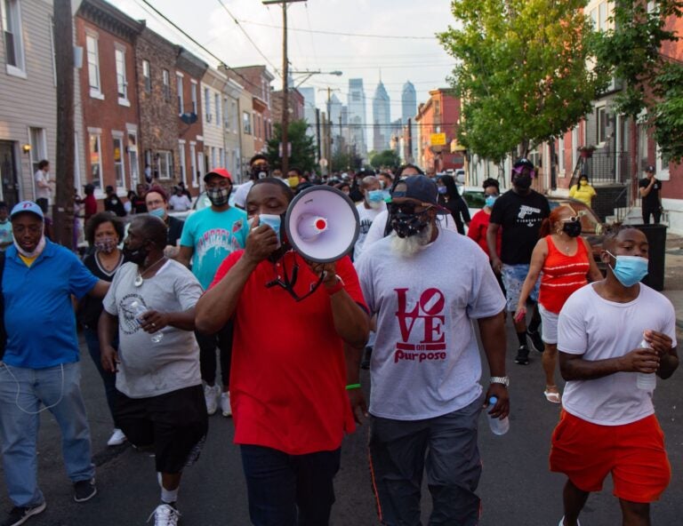 Councilmember Kenyatta Johnson led a protest chant, “Don’t shoot, I want to live” as residents fed up with gun violence marched through South Philadelphia. (Kimberly Paynter/WHYY)