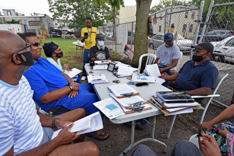 Residents meet in South Camden on August 6 to compile petitions they've circulated and plan strategy in an effort to return nonpartisan voting to the city. (Photo by April Saul for WHYY)