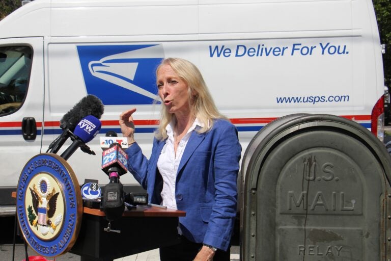 U.S. Rep. Mary Gay Scanlon joins federal, state and local officials at Second and Spring Garden streets to call for emergency funding for the struggling U.S. Postal Service. (Emma Lee/WHYY)