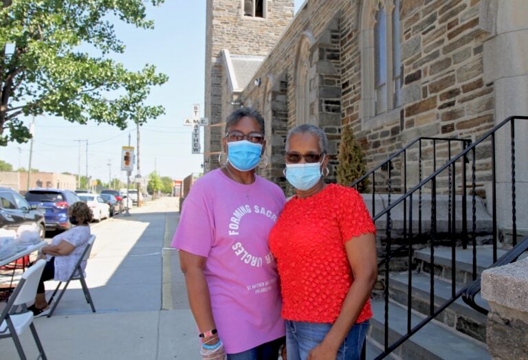 Lethonia Dennison and Beatrice Sims are ministers at St. Matthew AME Church, and have been giving out census information with free meals for those affected by COVID-19. (Ximena Conde/WHYY)