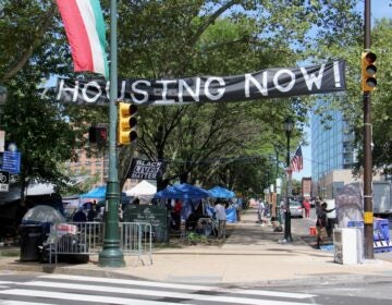 A homeless protest encampment occupies Von Colln Field on the Ben Franklin Parkway