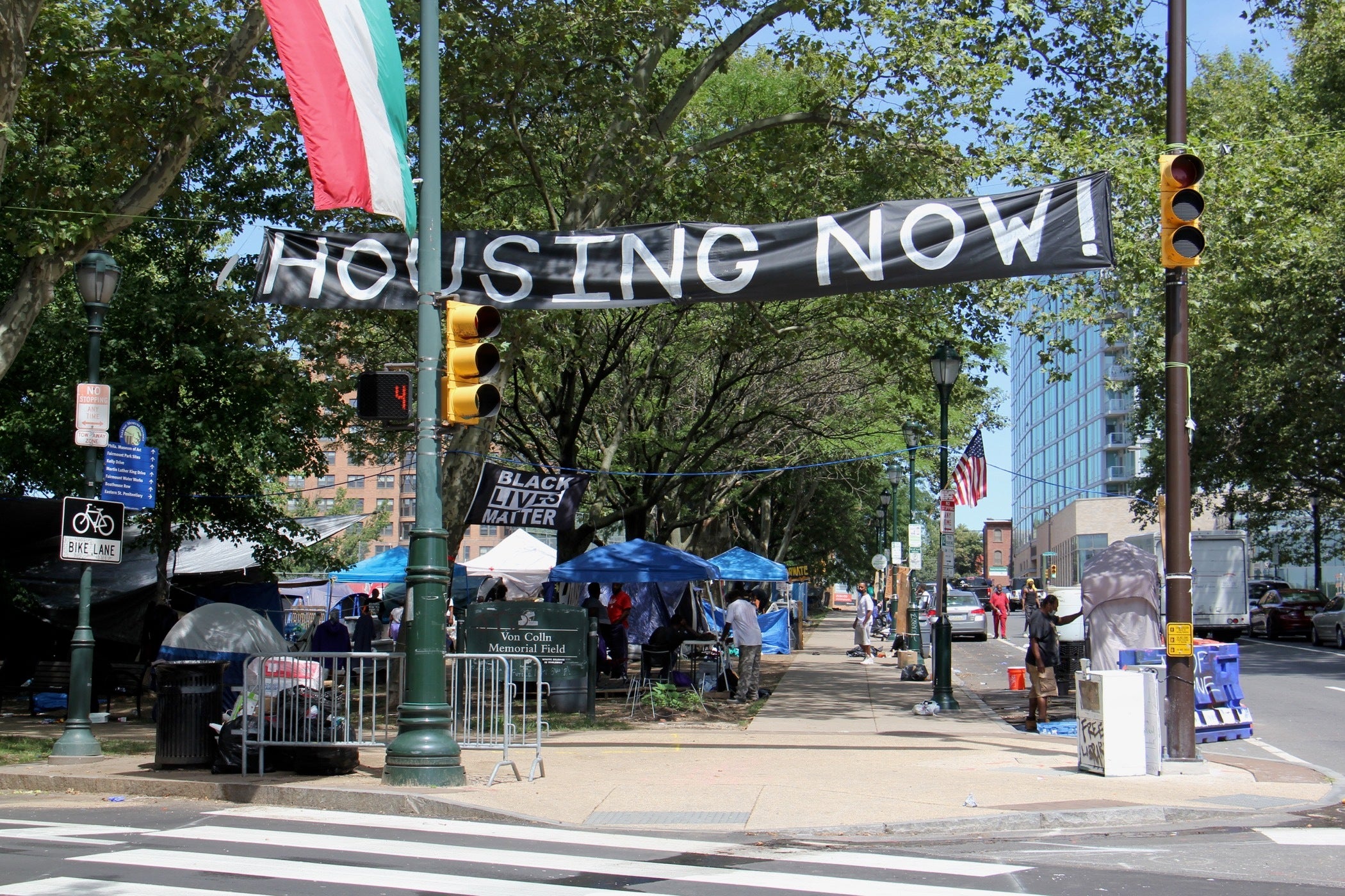A homeless protest encampment occupies Von Colln Field on the Ben Franklin Parkway