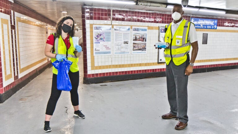 Jessica Mangold (left) and Leon Vaughn (right) are SEPTA social distancing coaches who hand out masks and encourage riders to stay safe during the pandemic. (Kimberly Paynter/WHYY)