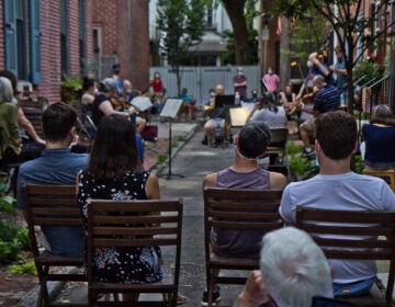 Philadelphia musicians playing music on a narrow rowhouse block