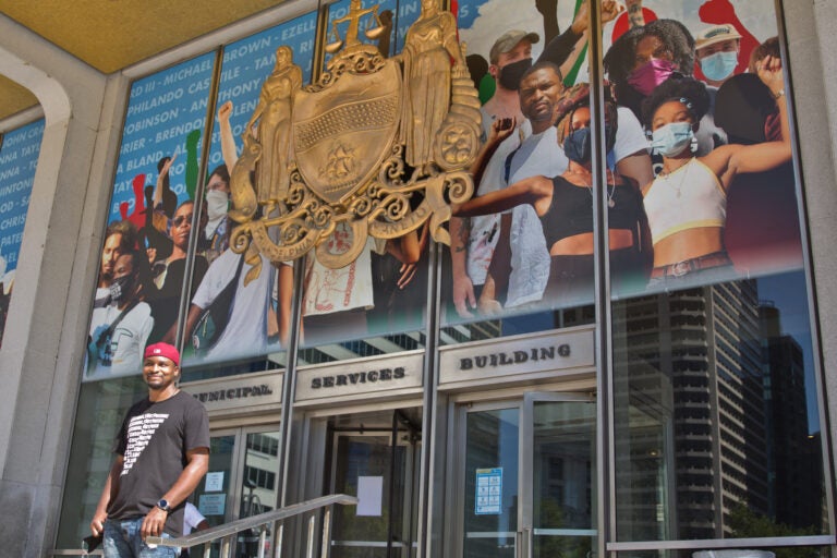 Mural artist Russell Craig included his own image in the crown-shaped collage of protesters now on Philadelphia’s Municipal Services building, behind where the statue of controversial Mayor Frank Rizzo stood until June. (Kimberly Paynter/WHYY)