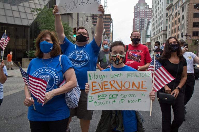 Becky Ansel marches at a protest demanding the extension of unemployment benefits for out of work musicians, stagehands and other out of work entertainment professionals. (Kimberly Paynter/WHYY)