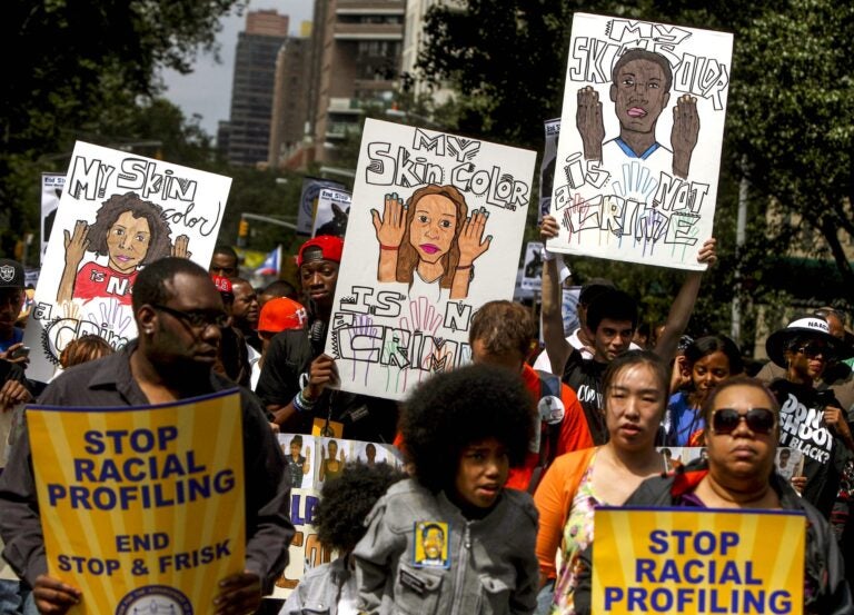 Protestors with signs during a silent march to end 'stop-and-frisk' program in New York. During the Bloomberg administration, civil rights groups went to court to end the NYPD's use of a tactic known as 'stop and frisk,' which involved detaining, questioning and sometimes searching people deemed suspicious by officers. Finding marijuana was often used to justify the policy. (AP Photo/Seth Wenig, File)