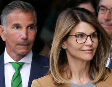 FILE - In this April 3, 2019 file photo, actress Lori Loughlin, front, and husband, clothing designer Mossimo Giannulli, left, depart federal court in Boston after facing charges in a nationwide college admissions bribery scandal. The famous couple pleaded guilty to charges in May 2020, and are scheduled to be sentenced on Friday, Aug. 21, 2020. (AP Photo/Steven Senne, File)