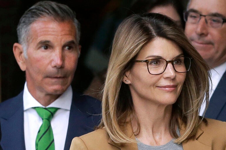 FILE - In this April 3, 2019 file photo, actress Lori Loughlin, front, and husband, clothing designer Mossimo Giannulli, left, depart federal court in Boston after facing charges in a nationwide college admissions bribery scandal. The famous couple pleaded guilty to charges in May 2020, and are scheduled to be sentenced on Friday, Aug. 21, 2020. (AP Photo/Steven Senne, File)