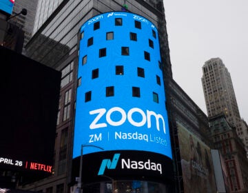 FILE - In this April 18, 2019, file photo shows a sign for Zoom Video Communications ahead Nasdaq IPO in New York.  (AP Photo/Mark Lennihan, File)