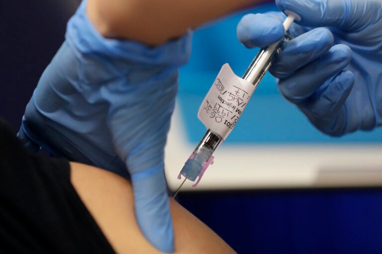 Volunteer is injected with the vaccine as part of an Imperial College vaccine trial, at a clinic in London, Wednesday, Aug. 5, 2020. Imperial College is working on the development of a COVID-19 vaccine. (AP Photo/Kirsty Wigglesworth)