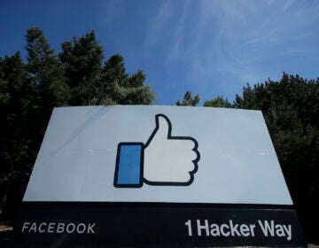 The thumbs up Like logo is shown on a sign at Facebook headquarters in Menlo Park, Calif., Tuesday, April 14, 2020. (AP Photo/Jeff Chiu)