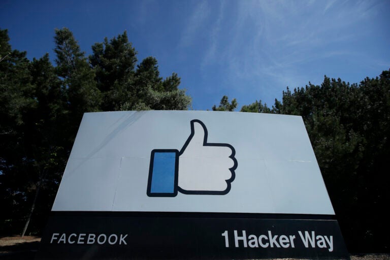 The thumbs up Like logo is shown on a sign at Facebook headquarters in Menlo Park, Calif., Tuesday, April 14, 2020. (AP Photo/Jeff Chiu)