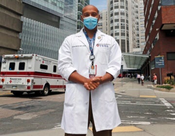 Alister Martin, an emergency room doctor at Massachusetts General Hospital, poses outside the hospital, Friday, Aug. 7, 2020, in Boston. Martin founded the organization 