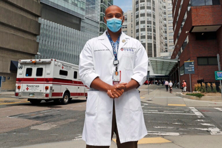 Alister Martin, an emergency room doctor at Massachusetts General Hospital, poses outside the hospital, Friday, Aug. 7, 2020, in Boston. Martin founded the organization 