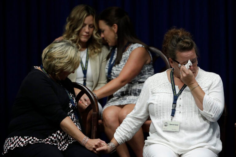 FILE - In this Aug. 14, 2018, file photo, victims of clergy sexual abuse, or their family members, react as Pennsylvania Attorney General Josh Shapiro speaks during a news conference at the State Capitol in Harrisburg, Pa. Pennsylvania Roman Catholic dioceses are facing recent lawsuits from people hoping a court decision in 2019 has shown a way around time limits for filing litigation. (AP Photo/Matt Rourke, File)