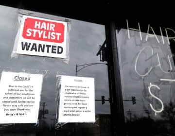 In this April 30 ,2020 file photo, a barber shop shows closed and hiring sign during the COVID-19 in Chicago.  On Thursday, Aug. 27, just over 1 million Americans applied for unemployment benefits last week, a sign that the coronavirus outbreak continues to threaten jobs even as the housing market, auto sales and other segments of the economy rebound from a springtime collapse. (AP Photo/Nam Y. Huh, File)