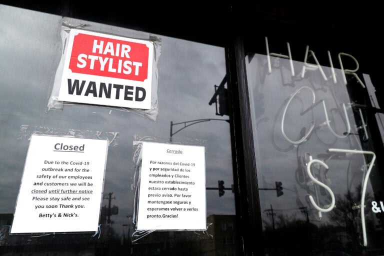 In this April 30 ,2020 file photo, a barber shop shows closed and hiring sign during the COVID-19 in Chicago.  On Thursday, Aug. 27, just over 1 million Americans applied for unemployment benefits last week, a sign that the coronavirus outbreak continues to threaten jobs even as the housing market, auto sales and other segments of the economy rebound from a springtime collapse. (AP Photo/Nam Y. Huh, File)