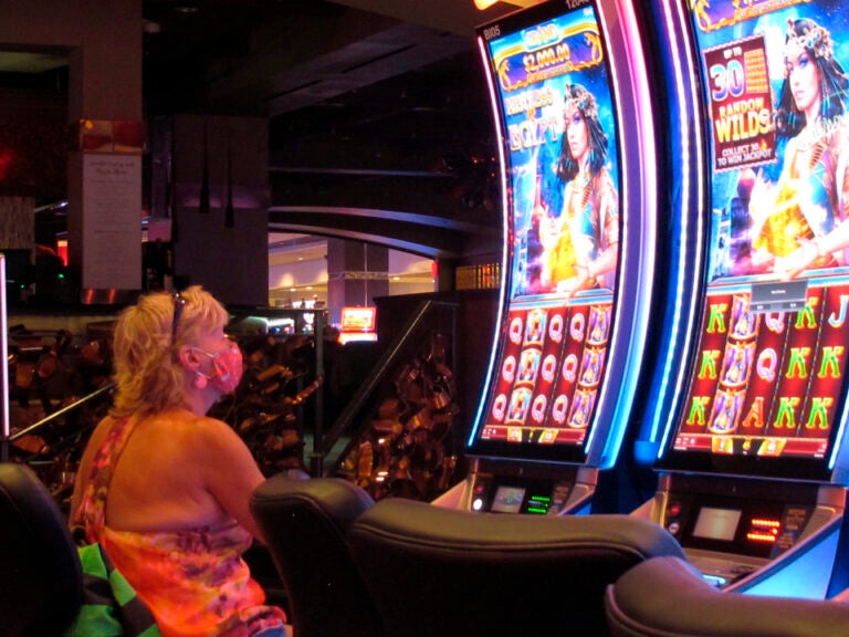 A woman plays a slot machine at the Golden Nugget casino in Atlantic City