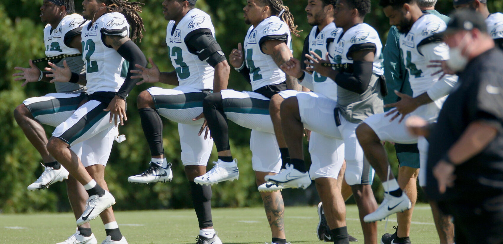 Philadelphia Eagles defenders warm up during NFL training camp