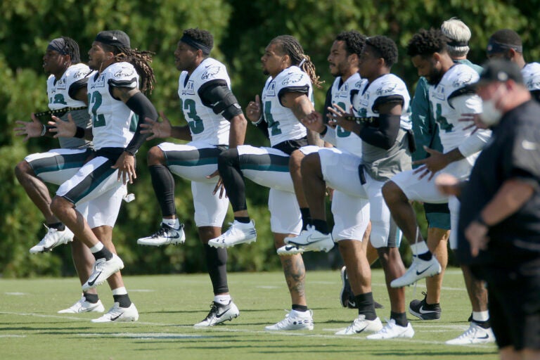 Philadelphia Eagles defenders warm up during NFL training camp