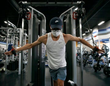 Benji Xiang, 32, wears a mask while working out at a gym