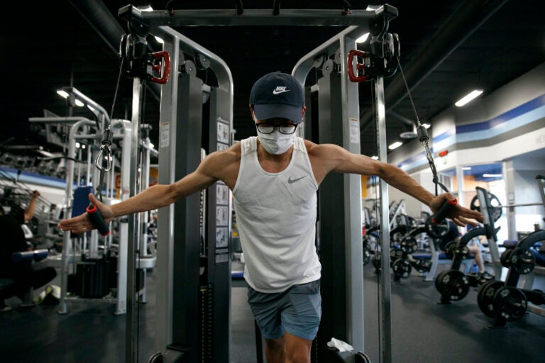 Benji Xiang, 32, wears a mask while working out at a gym