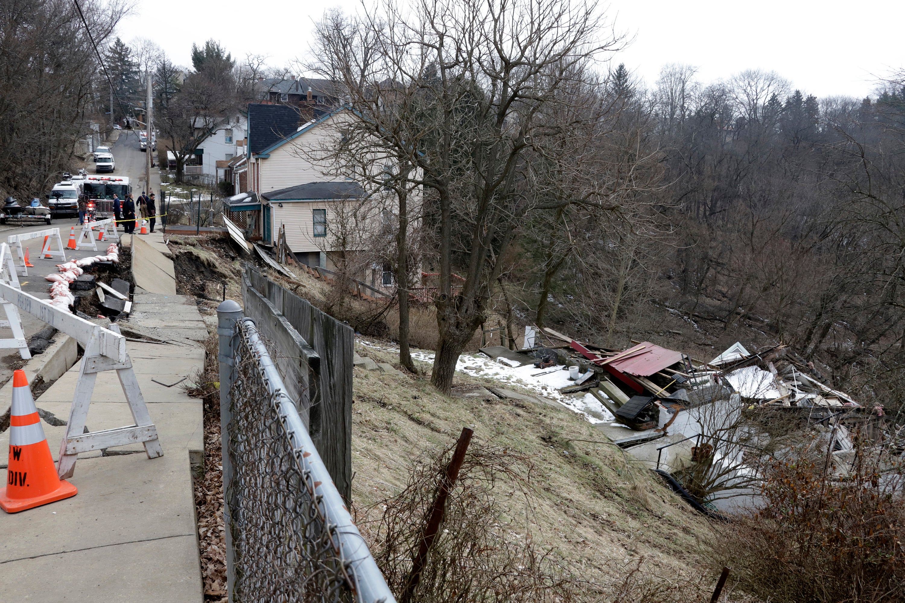 Pittsburgh Public Safety workers inspect a house that collapsed due to a landslide