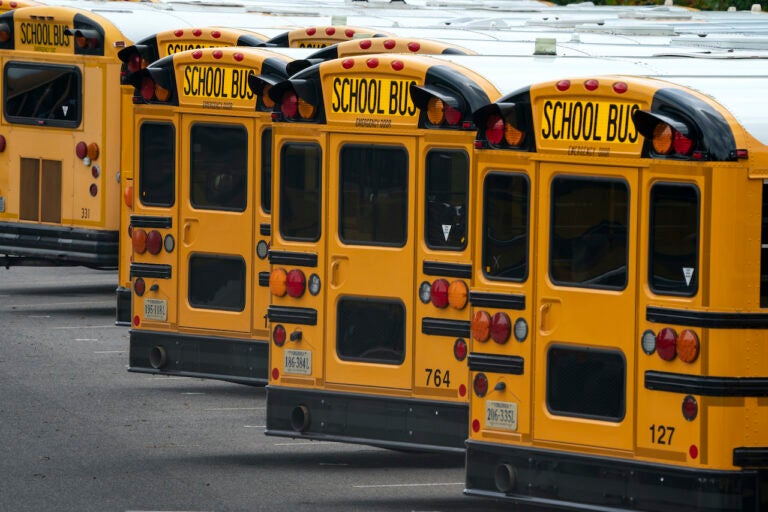 Fairfax County Public School buses are lined up at a maintenance facility